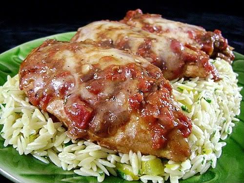 /><br/> <br/> I love finding a new recipe to cook chicken-we eat so much of it here that a variety of go to favorites is a wonderful thing.<br/> <br/> This recipe was reviewed on the Taste of Home board many times over and declared a winner.<br/> <br/> I don't normally buy canned soup that isn't low sodium, and French Onion soup in a can isn't low sodium at all, so I don't add any extra salt to the dish-the amount of salt in the soup is plenty for us. By all means, feel free to season the chicken with salt and add some to the sauce if you so choose. I season the chicken with freshly ground pepper only.<br/> <br/> I love shallots but don't always have them in the house.....on the occasion that I don't have them, I chop some onion and crush 1 clove of garlic for this. I also don't use as much thyme as the original recipe calls for-a hefty 3/4 tsp. is plenty for us.<br/> <br/> My skillet isn't oven ready, so what I do is brown the chicken in a nonstick skillet, then transfer it to a 13x9-inch glass baking dish. I make the sauce in the skillet I browned the chicken in to take advantage of all those browned bits in the pan, then pour the sauce over the chicken and pop the casserole dish in the oven. I also wait until the last 5 minutes to top with the Swiss cheese. I'm not normally a fan of Swiss cheese, but I have to say, in this dish, it ROCKS!<br/> <br/> The chicken is SO nice and moist and the combination of flavors in the sauce....heavenly. I would call the sauce in this recipe an accompaniment to the chicken-I usually have enough to generously spoon over the chicken but not enough to really dress the pasta-which is fine here. If you want more sauce, I suggest not reducing it much on the stove top-maybe just combine the ingredients and bring it up to a bubble before adding it to the chicken.<br/> <br/> I love serving this with orzo. The one in the photo has sautéed yellow pepper, onion, garlic and some chopped fresh parsley added to it. I find orzo a nice sidekick to the chicken.<br/> <br/> This would be a wonderfully delicious-and EASY-dish to serve dinner guests too. It's so simple to put together. The original poster said that it's also wonderful done in a crock pot....simply sauté the chicken breasts, place them in a slow cooker, add the sauce ingredients and cook on High for 4-6 hours. Garnish with Swiss cheese before serving. What a great idea for a busy day.<br/> <br/> I'm so glad I was introduced to this recipe-it's become a favorite in this house!<br/> <br/> <br/> Carol<br/> <br/> <br/> <br/> <img src=